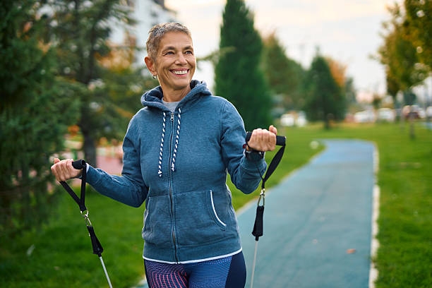istock Senior woman exercising outdoors with resistance band 2250823900