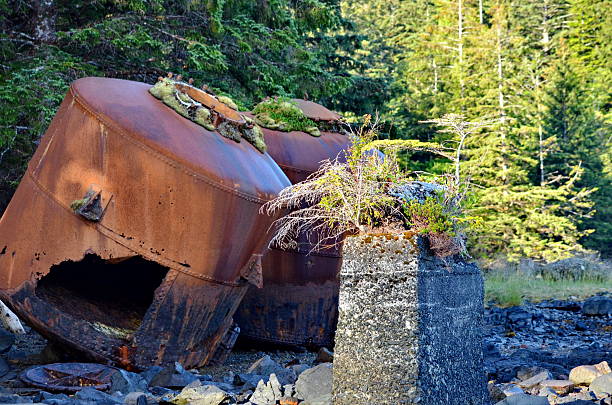 Old rusting machinery and signs at the abandoned Whaling Station at Rose Harbour in Haida Gwaii, BC, Canada