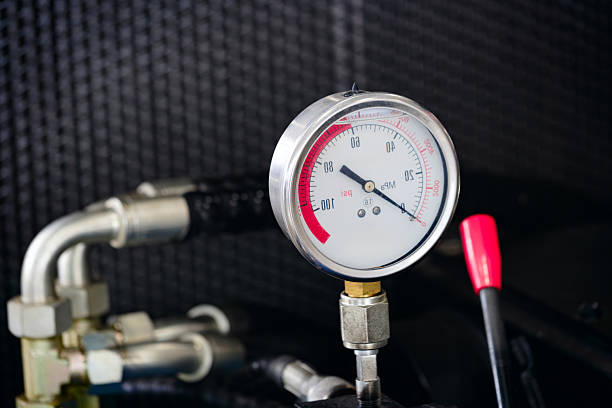 istock Hydraulic machine with a control handle and a high-pressure fluid gauge. Industrial concept background 2250828944