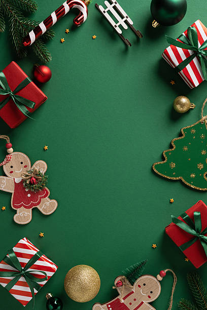A vertical green backdrop framed by presents, gingerbread, Santa and sleigh accents captures a joyful Christmas and NewYear mood in a festive, cozy setting