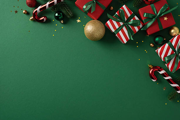 istock Vibrant holiday scene with gift, candy cane, ornament, and pine decor on a green backdrop, conveying Christmas and New Year celebration and greeting with festive color and lively texture 2250829072