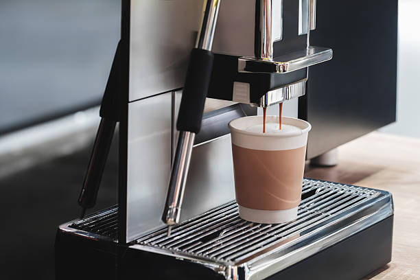 istock A coffee machine with a cup of coffee in it. The cup is brown and white 2250829772