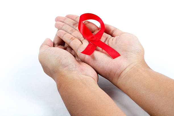 istock both hands holding a red ribbon symbolizing World AIDS Day 2250830643
