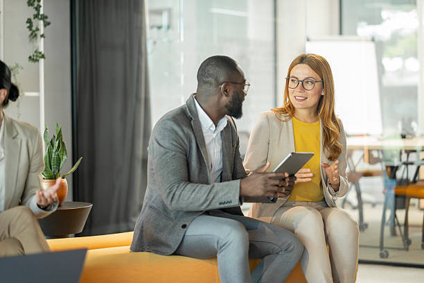 istock Business colleagues using digital tablet, discussing in modern office 2250833894