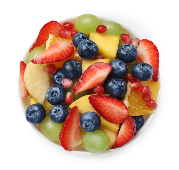 istock Tasty fruit salad in bowl isolated on white, top view 2250836874