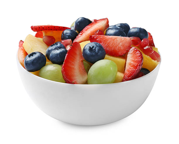 istock Tasty fruit salad in bowl isolated on white 2250836875