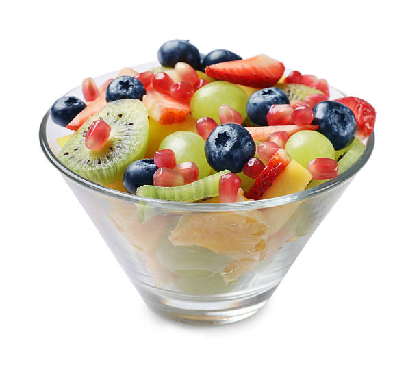 istock Tasty fruit salad in bowl isolated on white 2250836878