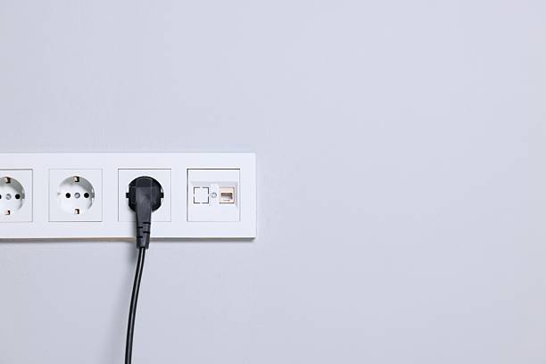 istock Power sockets and electric plug on grey wall, space for text 2250837205