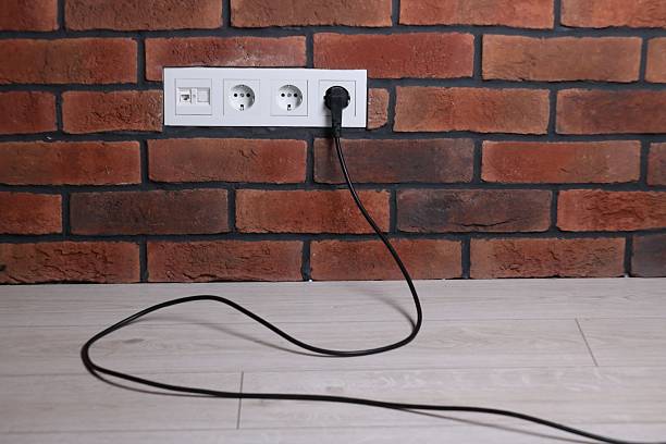 istock Power sockets and electric plug on brick wall 2250837210