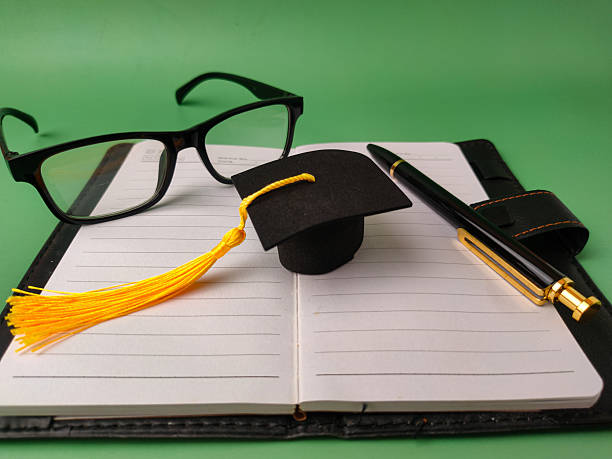 The image depicts items commonly associated with education and academia, suggesting a theme of learning or graduation