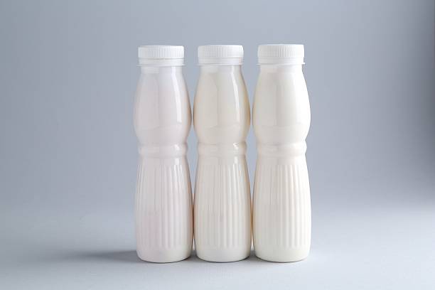 istock Tasty yogurt in bottles on light grey background 2250838559