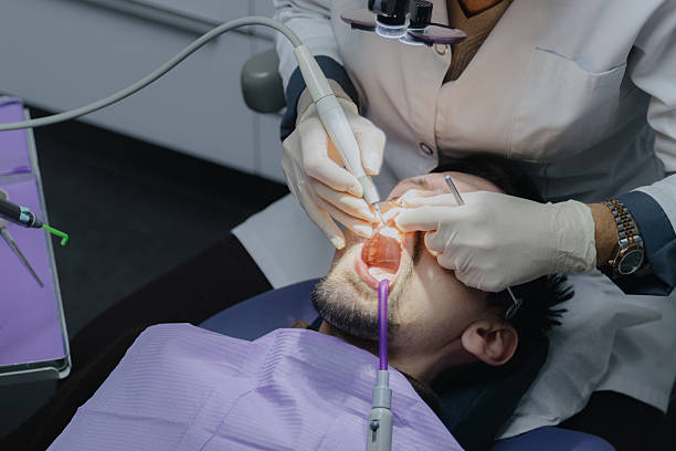 istock An unrecognizable dentist wearing white gloves performs a professional cleaning procedure on the front teeth. 2250841488