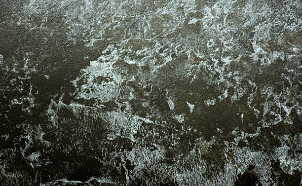istock Black marble, polished natural stone surface with white wavy inclusions, close-up. 2250843933