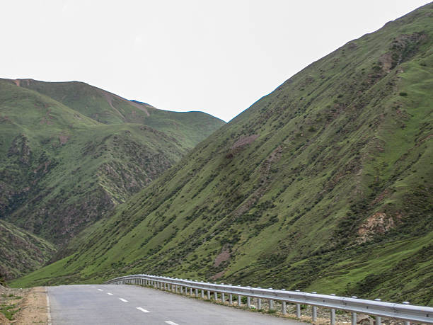 istock A scenic road winding through green mountainous landscape under overcast sky 2250848259
