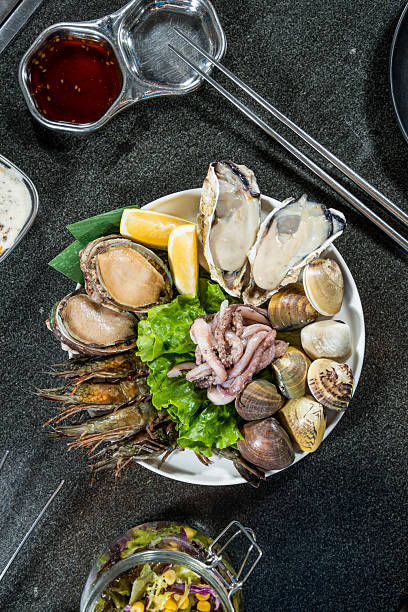 istock fresh seafood platter with oyster clam shrimp squid and garnish 2250848799