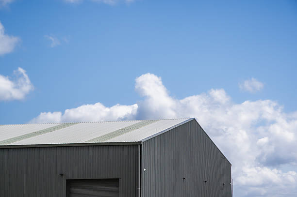 istock Low angle view of steel shed against blue sky 2250859653