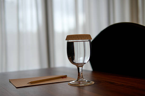 istock Covered Water Glass and Pencil on Table with Blurred Background 2250861436