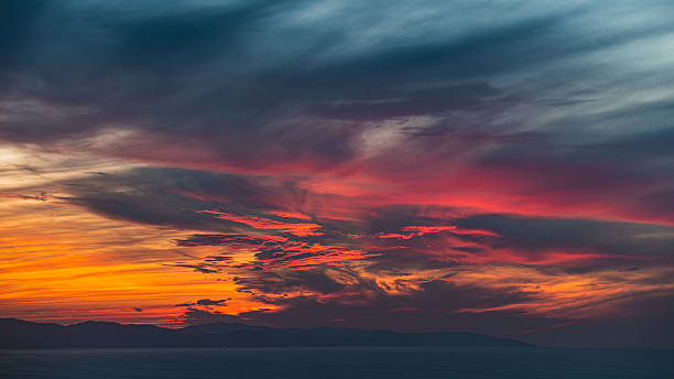 istock Dramatic Sunset Sky with Vibrant Clouds Over Mountain Horizon 2250861872