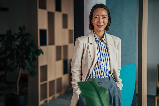 istock Asian businesswoman smiling at modern creative office workspace 2250862814