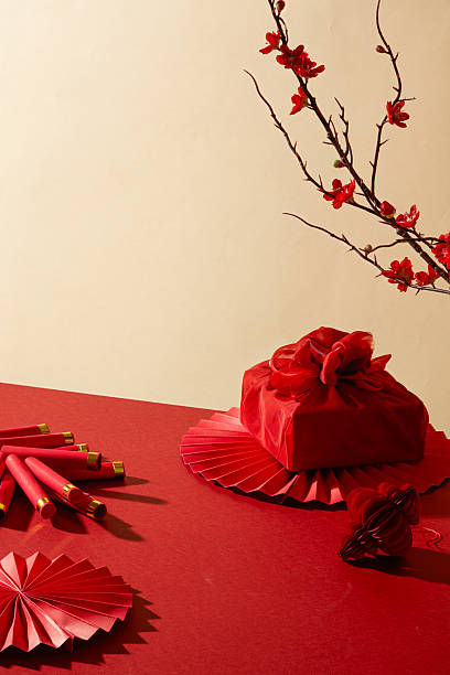 istock Vertical scene with fabric gift, floral branches and red decorative elements. Suitable for print posters, web banners and Tet holiday themed product design. Chinese new year background, holiday concept 2250865539