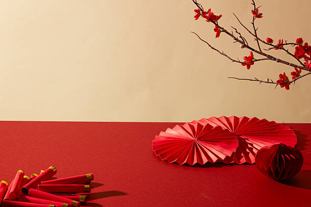 istock Festive scene with red paper fan and decorative branches on beige backdrop. Designed for large banners, website headers and Lunar New Year promotions. Background for lunar new year 2250865543