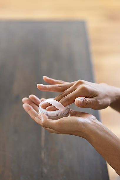 Close-up of Woman’s Hands Using Powder Puff