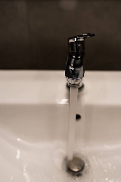 istock Faucet with flowing water in a bathroom. 2250872303