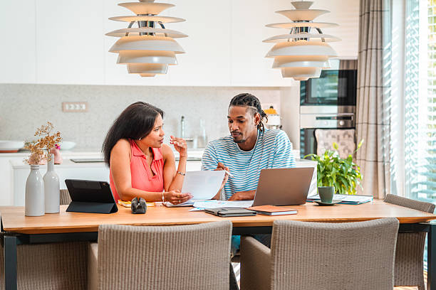 istock Mixed Race Couple Collaborating on Home Finances with Devices 2250874462