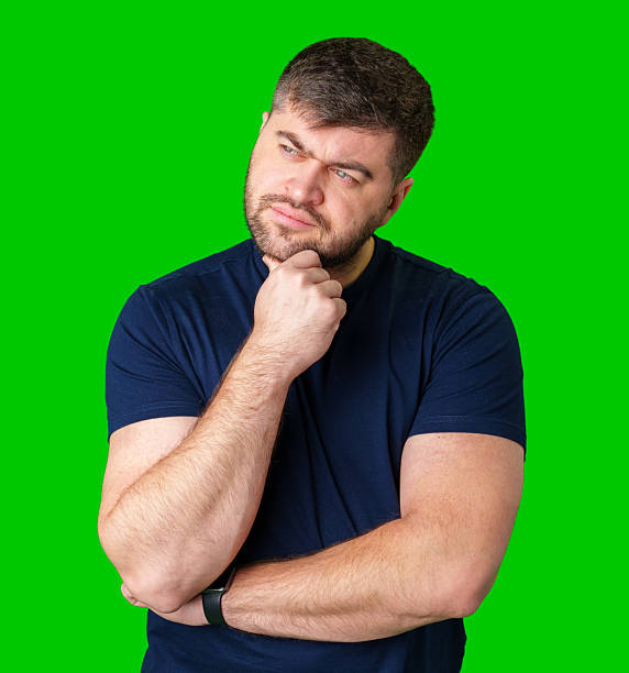 istock A man thoughtfully ponders on a bright green background 2250885507