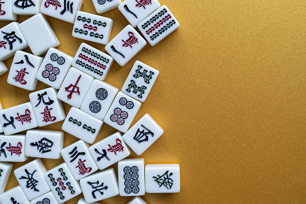 istock Mahjong tiles lined up on a golden background 2250885601