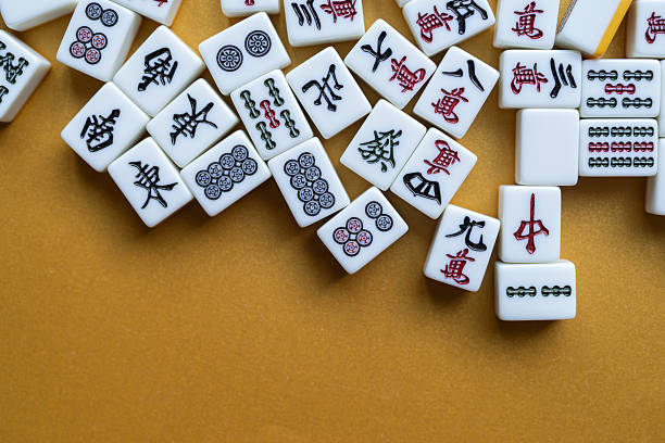 istock Mahjong tiles lined up on a golden background 2250885615
