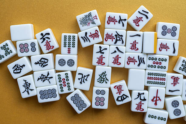 istock Mahjong tiles lined up on a golden background 2250885619