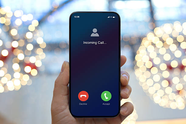 istock man hand hold phone with incoming call on screen Christmas 2250885821