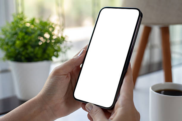istock Female hand holding phone with isolated screen over table cafe 2250885976