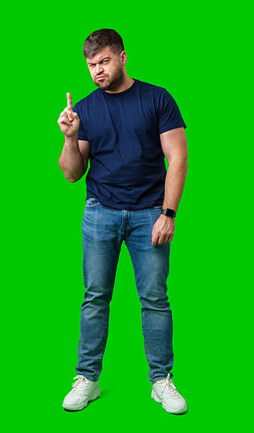 istock A man thoughtfully ponders on a bright green background 2250888009