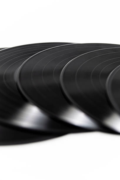 Studio shots of vinyl records, turntable details and hand interactions, capturing the nostalgic mood of analog music with clean lighting and a minimalist background.