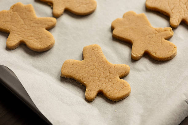Overhead image of raw gingerbread cookies in a tray, ready to be baked. Ideal for editorial food features, holiday recipe articles, cookbooks, and lifestyle content highlighting festive baking, family traditions, and seasonal desserts.