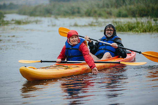 istock Senior couple kayaking on a lake in rain 2250893382