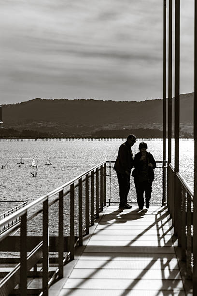 Silhouette of family on the pier at dramatic morning