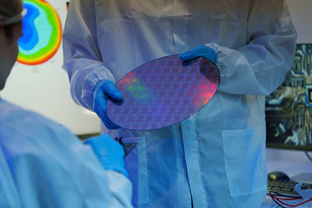 istock International male and female technicians wearing sterile suits work at a semiconductor manufacturing plant using microscopy (PHOTO) 2250898110