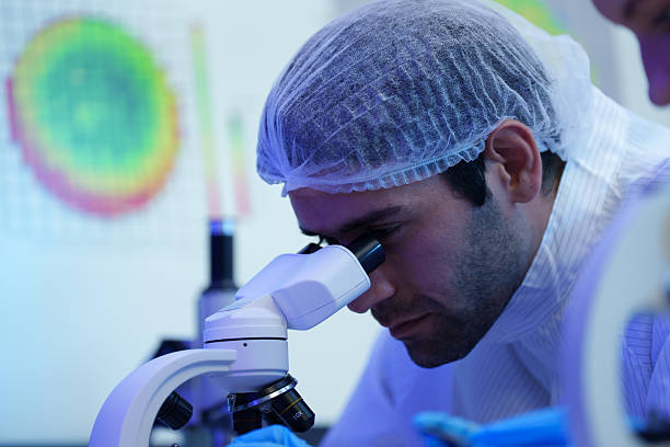 istock International male and female technicians wearing sterile suits work at a semiconductor manufacturing plant using microscopy (PHOTO) 2250898154
