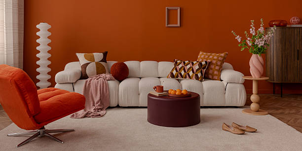 istock Modern interior with curved sofa and geometric cushions in warm tones. 2250899597