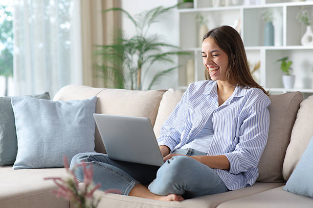 istock Funny woman in blue laughing while checking laptop content 2250903085