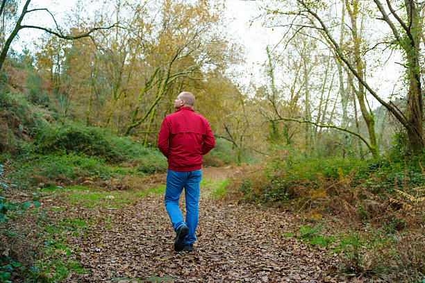 istock Man walking forest path enjoying autumn nature hike 2250903445