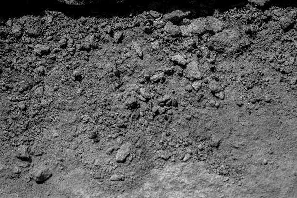 Black-and-white concrete erosion vignette for concept of decay and structural aging