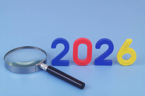 istock Numbers 2026 and magnifying glass on blue background. 2250904021