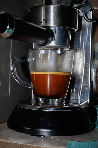 istock Close-up of Espresso Coffee Being Poured into a Glass Mug from a Modern Automatic Coffee Machine, Home Barista and Breakfast Concept 2250908211