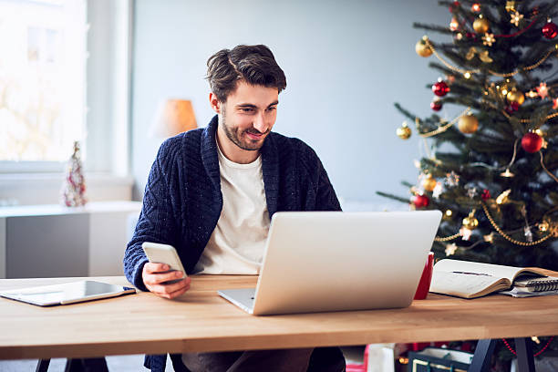 istock Young man doing Christmas shopping online paying with mobile phone 2250912208