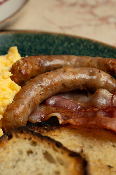Tasty breakfast with eggs, sausages, toasts and cup of coffee. American breakfast. Top view
