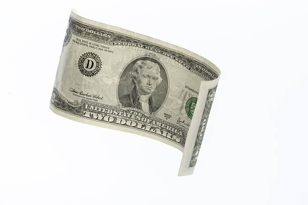 Two dollar bill is gracefully suspended, revealing its unique features and historical significance.